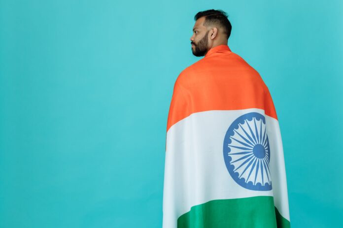 bearded man posing with an indian flag
