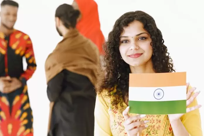 group of people with smiling young woman holding india flag