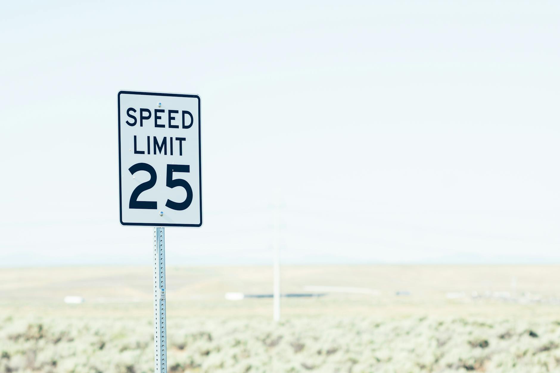sign on roadside with speed limit
