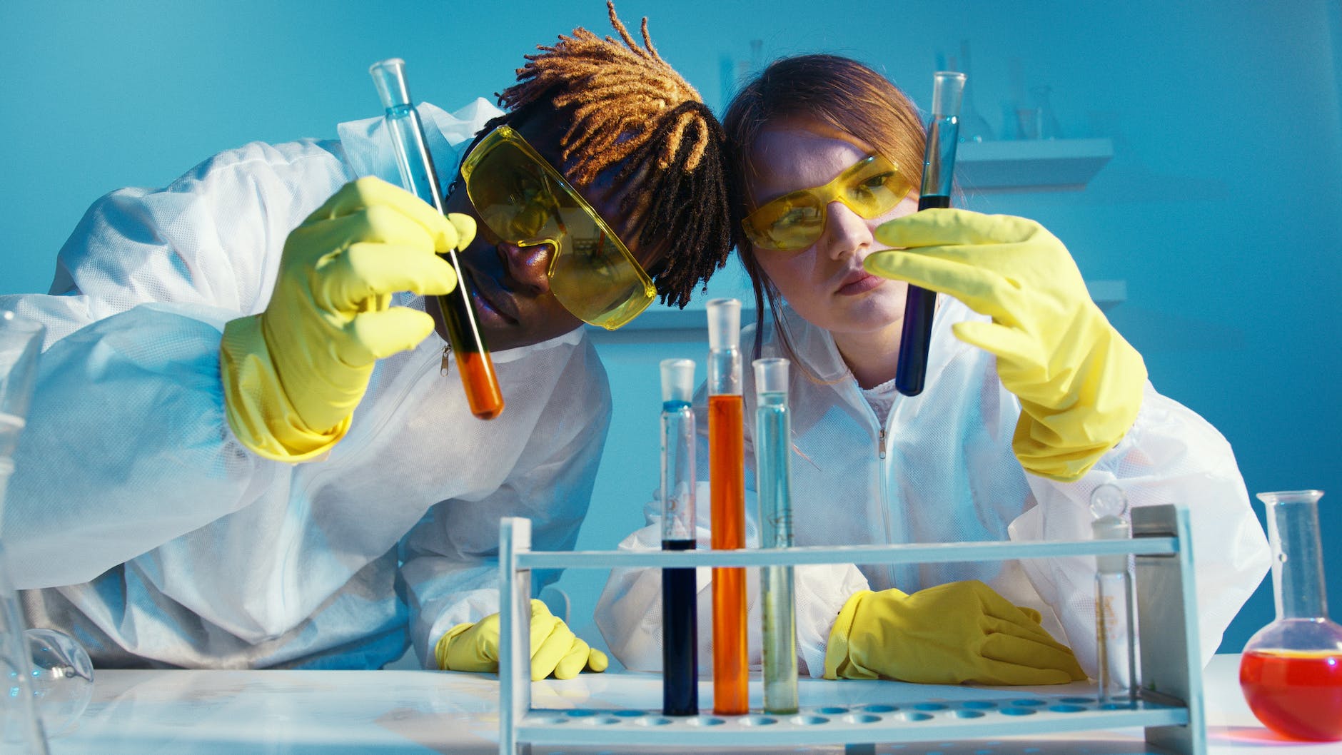 a man and a woman holding a test tube