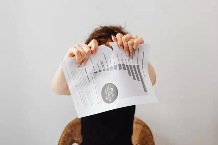 a person tearing apart a piece of paper