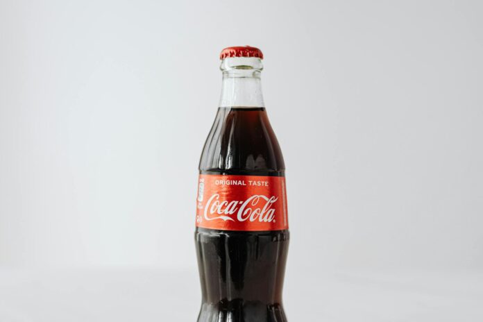 closed bottle of coke on white background